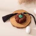 Detailed view of handmade Xiangyunsha silk pumpkin pendant with elegant long tassel cord - Gourd Persimmon Shape (FHS25-3011-1)