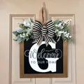 Decorative wooden front door sign featuring a large letter G with welcome message and striped bow - Letter G