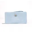 Close-up detail of a light blue women's long wallet with elegant rhinestone hardware - Blue