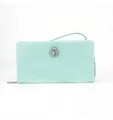 Close-up of mint green long wallet with elegant rhinestone jewel and wrist strap. - Green