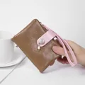 Small brown cracked leather wallet for women with pink wrist strap and pearl charm - Coffee