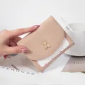 Chic apricot tri-fold short wallet for women featuring a cute gold bear metal charm - Apricot