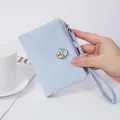 Elegant light blue short wallet with wrist strap and crystal ornament for stylish women - Blue