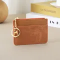 Slim brown textured leather women's card holder with gold keychain and top zipper - Tan