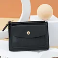 Compact black PVC mini wallet featuring a top zipper and front gold snap pocket. - Black