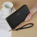 Elegant black long wallet for women with wrist strap and cross-hatch leather texture. - Black