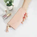 Elegant pink slim long wallet for women featuring a heart tassel charm and envelope flap - Pink