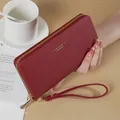 Burgundy long zip-around women's wallet with wristlet strap and stylish textured finish - Red