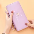 Elegant purple long wallet with wrist strap featuring butterfly print and gold charm. - Purple