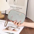 Detailed view of the blue floral print double zipper clutch bag with wrist strap - Blue