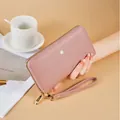 Elegant dusty rose women's long wallet with pebble grain texture and wristlet strap - Pink