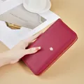 Elegant wine red long wallet with lychee leather texture and gold leaf detail. - Red