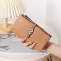 Detailed view of women's long camel leather wallet with elegant buckle and zip. - Long Bifold / Tan