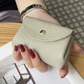 Premium beige genuine leather mini coin purse with lychee texture and gold button - Cream