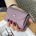 Compact purple pebbled leather mini coin purse featuring secure snap button closure - Purple