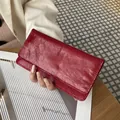 Elegant slim red long wallet in glossy crinkled leather with minimalist design for women. - Red