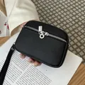 Compact black pebble grain leather mini coin purse featuring double zippers and wrist strap - Black