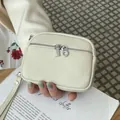 Cream pebbled leather mini coin purse with double silver zippers and wrist strap - Off White