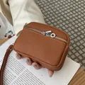 Elegant brown pebbled leather mini coin pouch with double silver zippers for daily use - Earthy Yellow