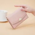 Elegant light pink pebbled leather wallet for women featuring a stylish gold clasp - Pink