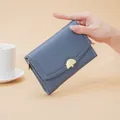 Elegant blue pebbled leather women's wallet featuring a gold semi-circular clasp. - Dark Blue