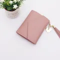 Compact dusty pink bifold wallet for women featuring a gold heart pendant and tassel charm - Tassel Style / Light Pink