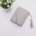Elegant grey mini trifold wallet for women featuring heart charm and tassel detail - Tassel Style / Gray