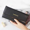Elegant black long wallet for women with gold-tone hardware and snap closure. - Black