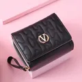 Elegant black women's short wallet with wavy quilting and golden V-logo hardware detail - Black