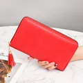 Red women's long woven clutch wallet with elegant tassel and secure zipper closure - Red