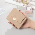 Elegant vintage tan frosted leather short wallet for women featuring a golden leaf clasp detail - Khaki