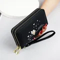 Elegant black leather long wallet for women featuring heart print and double zipper design - Black