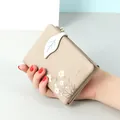 Elegant khaki short faux leather wallet featuring daisy prints and a leaf-shaped closure - Khaki