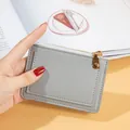 Minimalist grey zipper card holder and coin purse with front card slot detail. - Light Gray