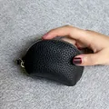 Minimalist small black genuine leather coin purse with zipper closure and textured finish - Black