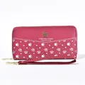 Detailed view of rose red long wallet with white paw prints and Forever Young metal logo - Red