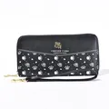 Detail view of a black long wallet with cute puppy paw prints and FOREVER YOUNG logo. - Black