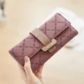 Elegant dusty rose long leather wallet for women featuring a tri-fold buckle closure - Burgundy