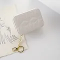 Elegant white quilted small lipstick pouch with gold keychain and star embroidery pattern - White