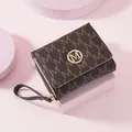 Stylish brown tri-fold women's wallet with 'M' monogram and gold logo - Coffee