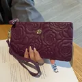 Purple embossed cowhide leather clutch bag with floral pattern and wristlet for women - Purple