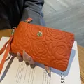 Orange embossed genuine leather clutch bag with camellia pattern for women - Orange Red