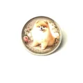 Detail view of a vintage round brooch with a fluffy Pomeranian dog and flower pattern - Pomeranian Among Flowers Style
