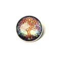 Detailed view of a vintage Tree of Life glass cabochon brooch on white background. - Tree
