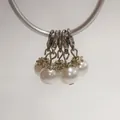 Detailed view of white pearl charms with silver lobster clasps and flower caps for DIY crafts - Lobster Clasp Flower Cap Pearl Pendant / Bright White