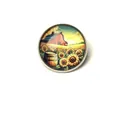 Macro detail of a vintage sunflower barn scene brooch with a glass cabochon finish - Sunflower Rural