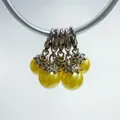 Close-up of five yellow pearl pendants with silver lobster clasps and flower caps - Lobster Clasp Flower Cap Pearl Pendant / Yellow