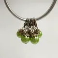 Close-up of light green pearl charms with silver lobster clasps and flower caps. - Lobster Clasp Flower Cap Pearl Pendant / Bright Green