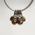 Detailed view of bronze pearl pendants with vintage silver flower caps and lobster clasps - Lobster Clasp Flower Cap Pearl Pendant / Bronze