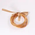Three-piece set of golden foil glitter jelly bangles with a decorative tan ribbon bow - Five-Piece Set / Antique Gold